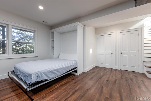 bedroom featuring dark wood-type flooring, recessed lighting, and baseboards