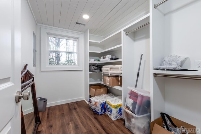 spacious closet featuring visible vents and dark wood finished floors