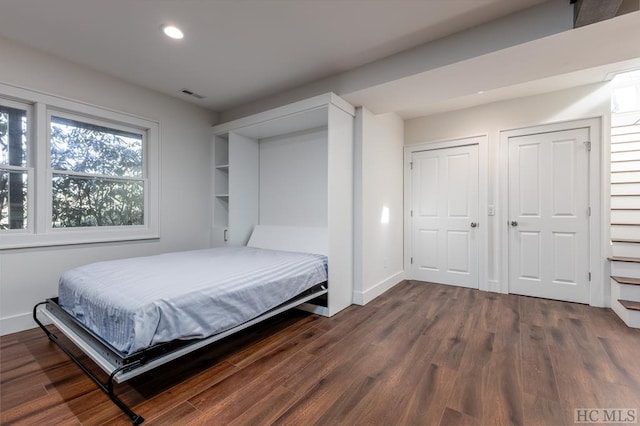 bedroom featuring visible vents, recessed lighting, dark wood-type flooring, and baseboards