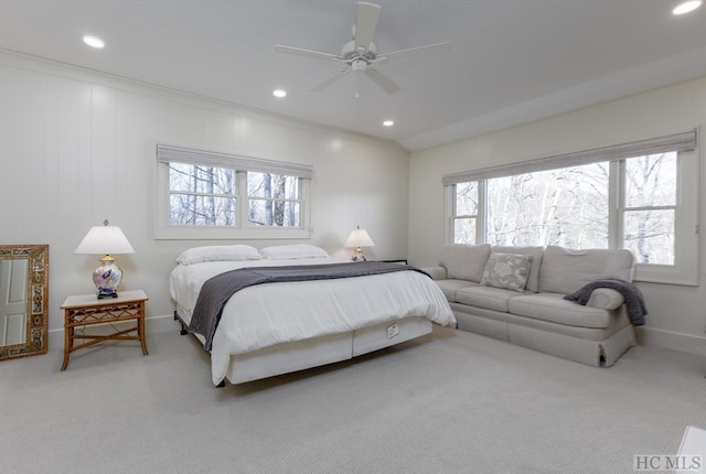 carpeted bedroom with ornamental molding and ceiling fan