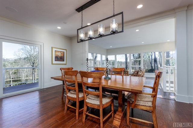 dining space with dark wood-type flooring and ornamental molding