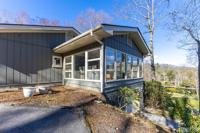 view of side of home featuring a sunroom