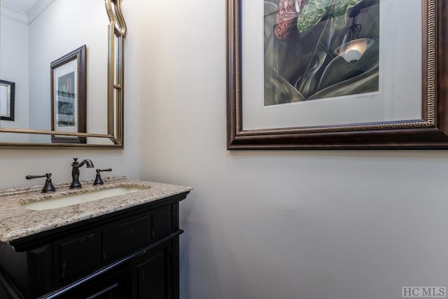 bathroom with ornamental molding and vanity