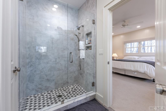 bathroom with ceiling fan and a shower with door