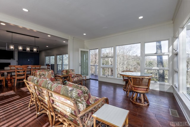 living room with visible vents, recessed lighting, wood-type flooring, and ornamental molding