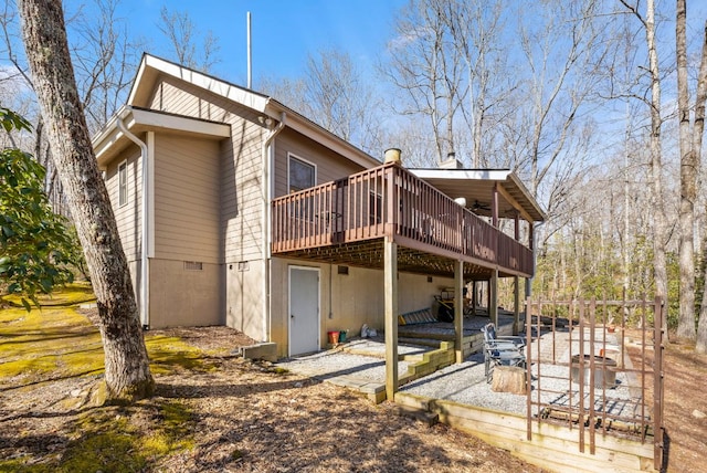 back of house featuring a wooden deck