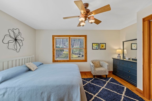 bedroom with ceiling fan and wood finished floors