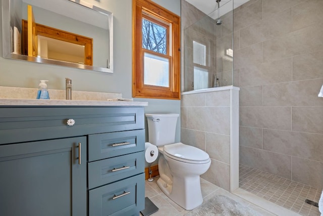 full bathroom featuring a walk in shower, tile patterned flooring, vanity, and toilet