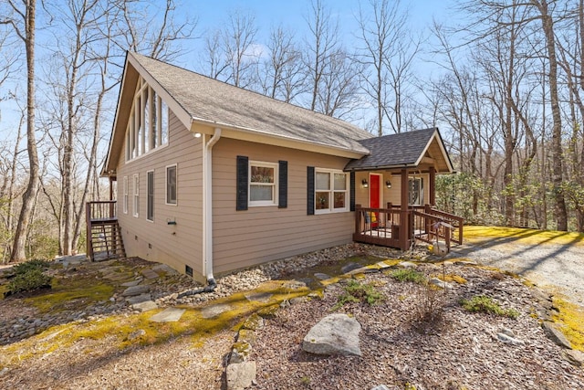 view of front of property featuring crawl space and a shingled roof