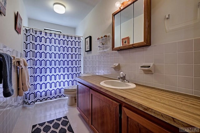 bathroom featuring tile walls, tile patterned flooring, vanity, walk in shower, and toilet