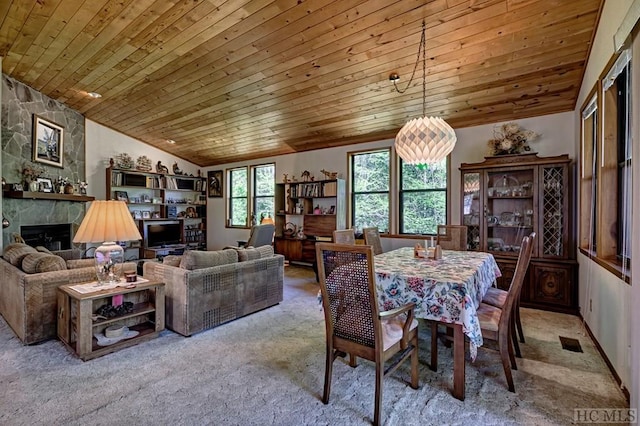 carpeted dining space with wood ceiling, lofted ceiling, and a fireplace