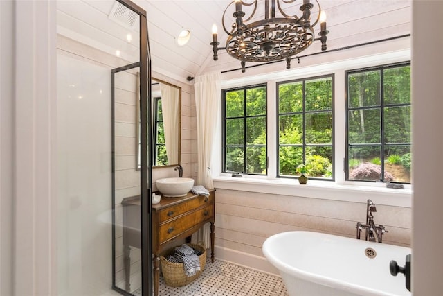 421 Easter Ln, Cullowhee, NC 28723 - full bath with healthy amount of natural light, a shower stall, a chandelier, wooden walls, and lofted ceiling