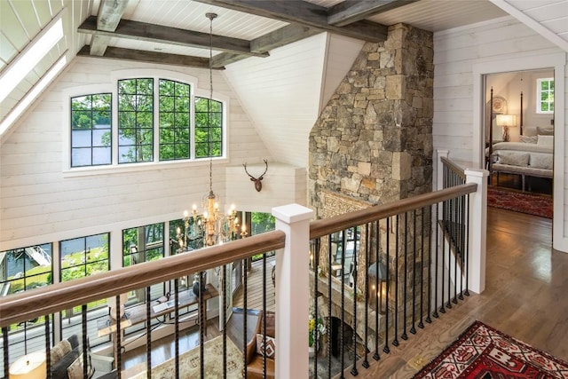 421 Easter Ln, Cullowhee, NC 28723 - corridor with a chandelier, an upstairs landing, wood finished floors, wood walls, and wood ceiling