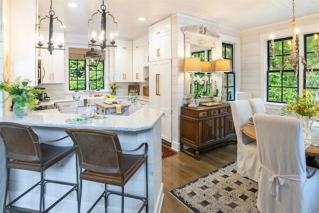 421 Easter Ln, Cullowhee, NC 28723 - kitchen with a chandelier, dark wood finished floors, white cabinetry, a peninsula, and pendant lighting