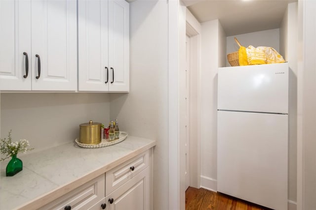 421 Easter Ln, Cullowhee, NC 28723 - kitchen with freestanding refrigerator, white cabinetry, and dark wood-style floors