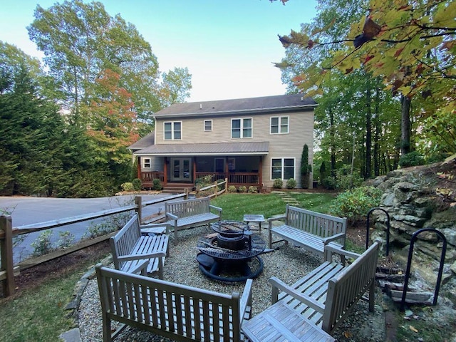 110 Kestrel Ct, Sapphire, NC 28774 - back of property featuring an outdoor fire pit and french doors