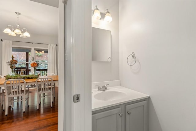 110 Kestrel Ct, Sapphire, NC 28774 - bathroom featuring a chandelier, vanity, and wood finished floors