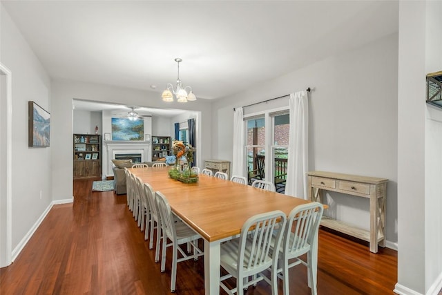 110 Kestrel Ct, Sapphire, NC 28774 - dining area with dark wood-type flooring, ceiling fan, a fireplace, and baseboards