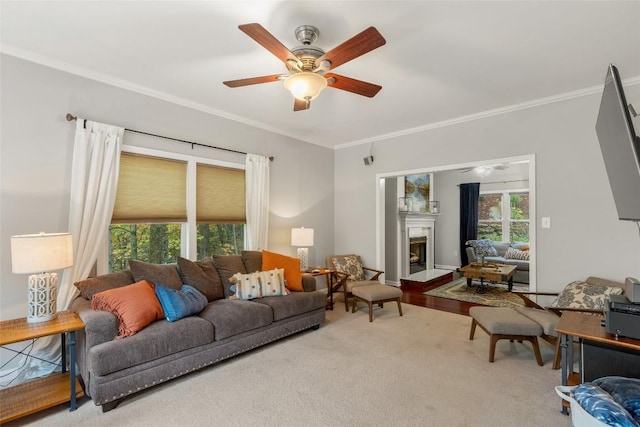 110 Kestrel Ct, Sapphire, NC 28774 - living area with crown molding, healthy amount of natural light, ceiling fan, and a fireplace with raised hearth