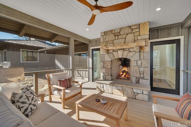 balcony featuring ceiling fan and an outdoor living space with a fireplace