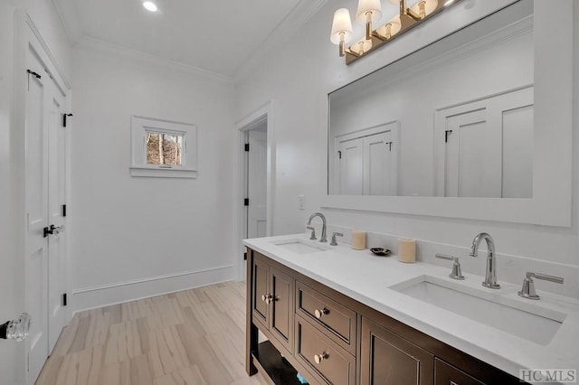 bathroom featuring wood-type flooring, crown molding, and vanity