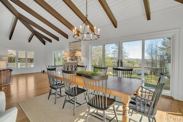 dining area with high vaulted ceiling, beamed ceiling, a notable chandelier, light hardwood / wood-style floors, and wooden ceiling