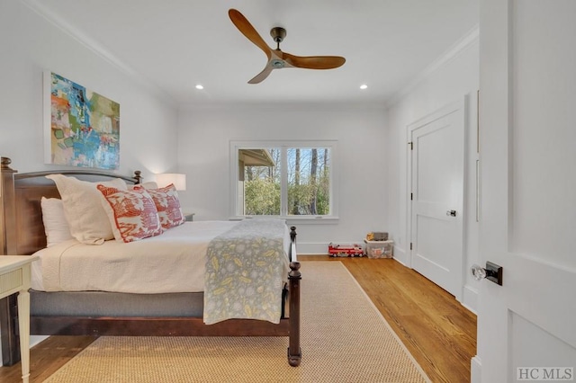 bedroom featuring crown molding, ceiling fan, and hardwood / wood-style floors