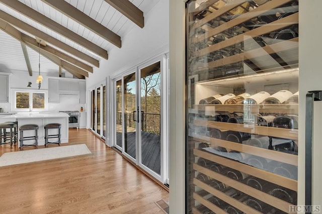 interior space with sink, wood ceiling, wood-type flooring, high vaulted ceiling, and beamed ceiling