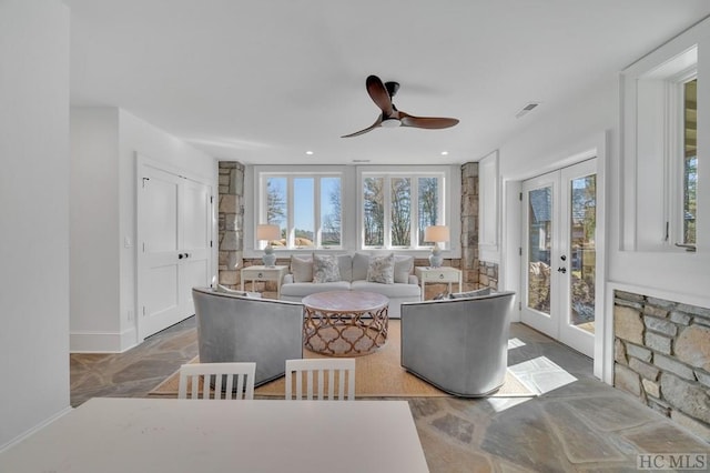 living room featuring french doors and ceiling fan