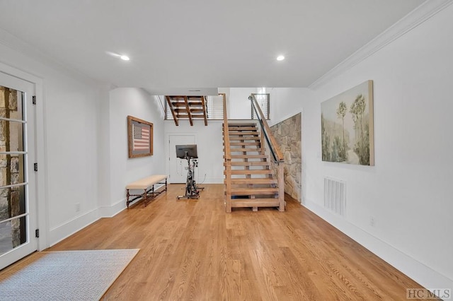 interior space with crown molding and light wood-type flooring