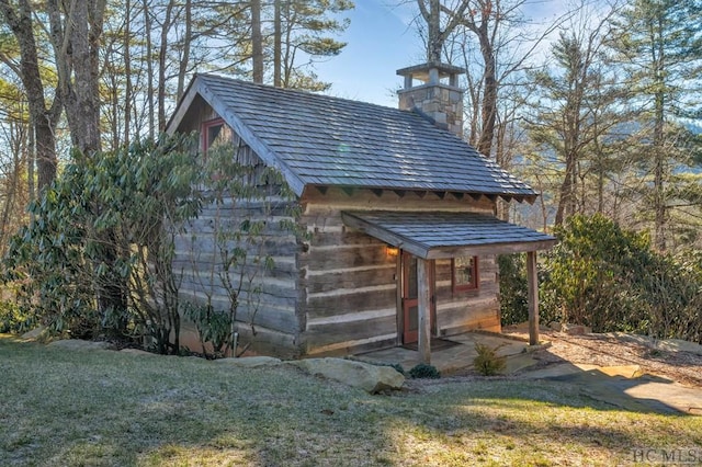 view of outbuilding with a lawn