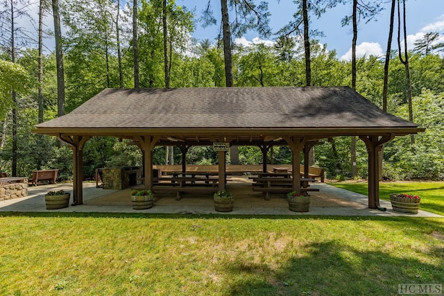 view of property's community featuring a lawn, a patio area, and a gazebo