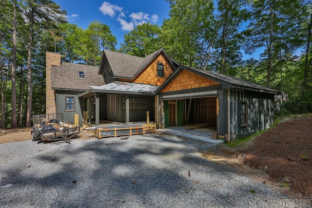 back of property featuring a garage