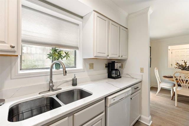 kitchen featuring a sink, dishwasher, crown molding, white cabinets, and light stone countertops