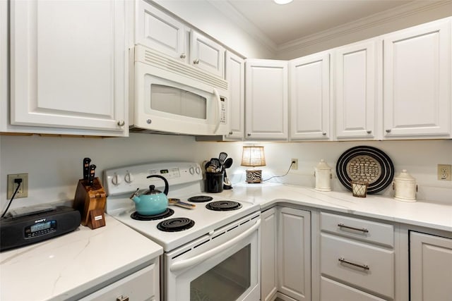 kitchen featuring light stone countertops, ornamental molding, white appliances, and white cabinets