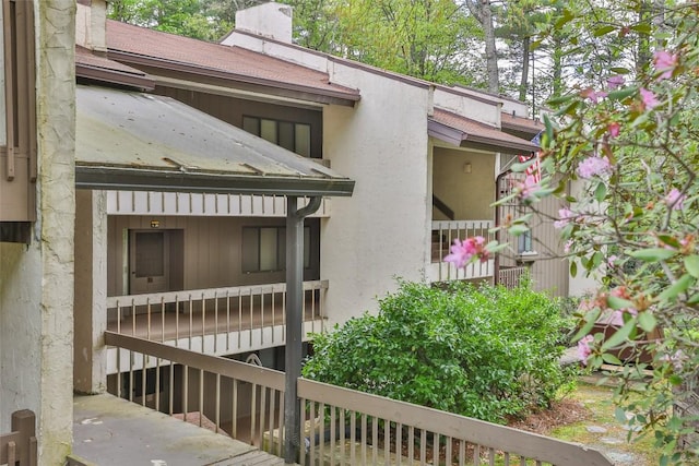 view of home's exterior with stucco siding and a chimney