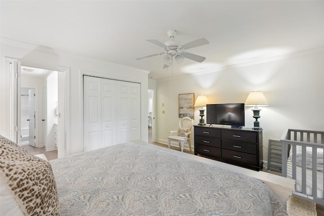 bedroom with a closet, baseboards, and ornamental molding