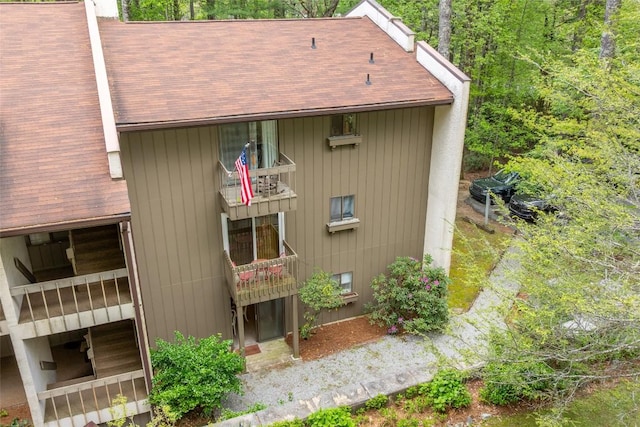 view of side of property featuring roof with shingles