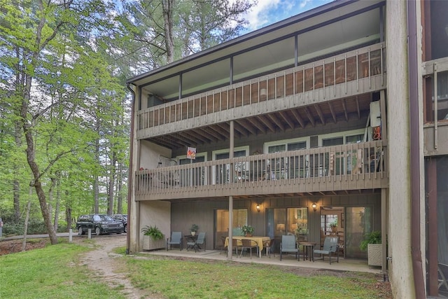 back of property featuring a patio area and a balcony