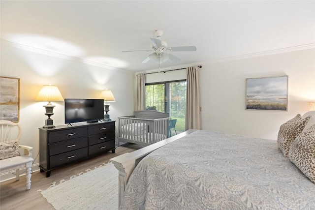 bedroom featuring a ceiling fan, light wood-style flooring, baseboards, crown molding, and access to exterior