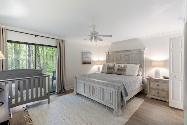 bedroom with a ceiling fan, light wood-style floors, and crown molding