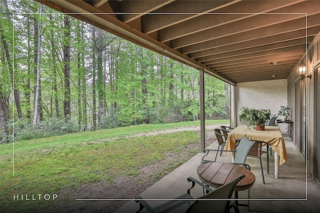 view of patio / terrace featuring a wooded view