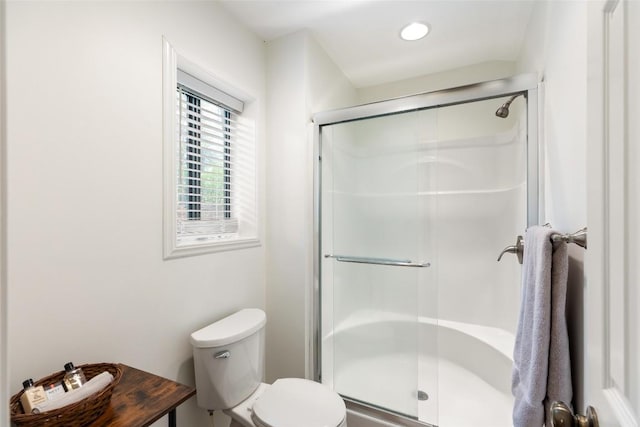 bathroom featuring a stall shower and toilet