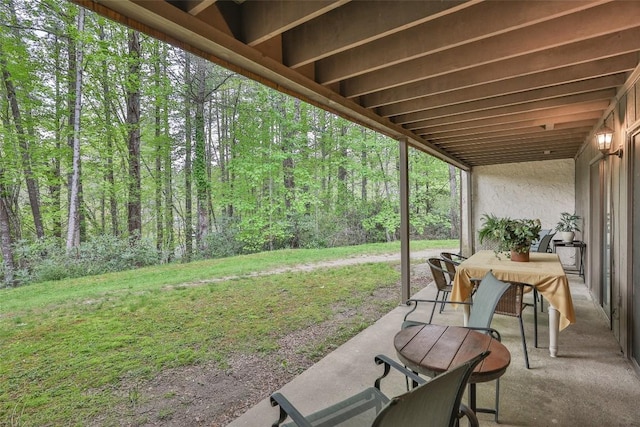 view of patio / terrace featuring a wooded view