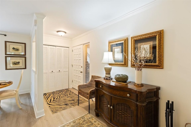 entryway with crown molding, baseboards, and wood finished floors