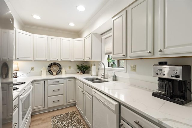 kitchen featuring white cabinetry, light stone counters, a sink, and white appliances
