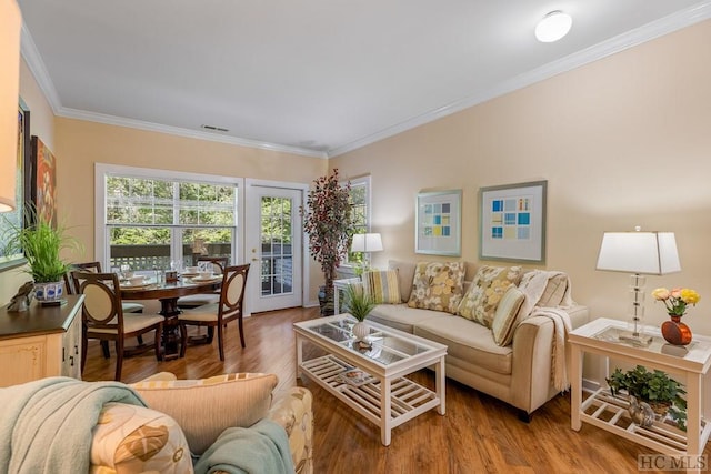 living room featuring hardwood / wood-style flooring and crown molding