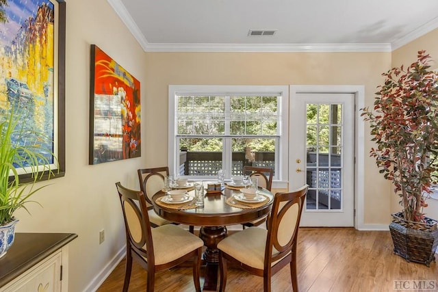 dining area featuring crown molding and wood-type flooring