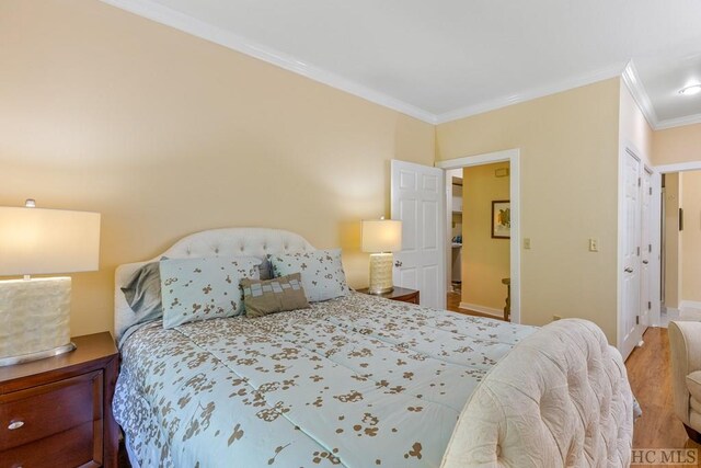 bedroom featuring crown molding and hardwood / wood-style floors