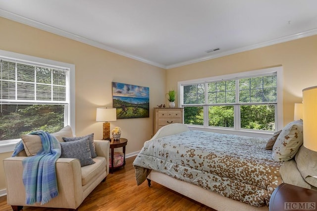 bedroom featuring hardwood / wood-style flooring and crown molding